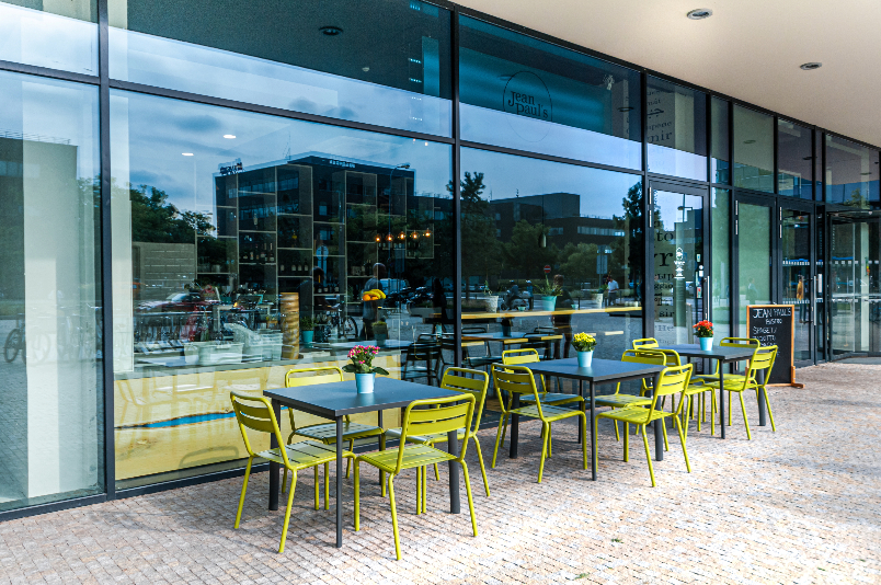Outdoor restaurant with green metal chairs