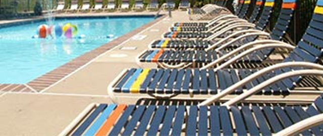 Color Striped Pool Lounge Chairs Lined Up Resort Patio