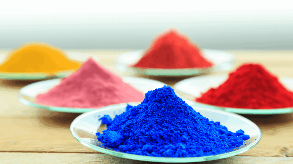 photo of colorful piles of powder coating on glass plates