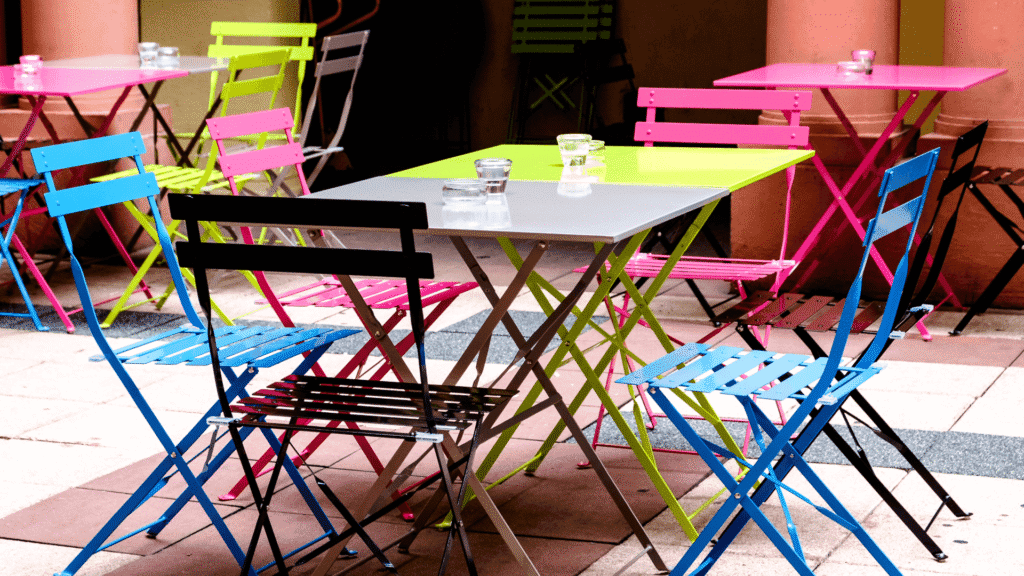 neon patio chairs and tables in an outdoor space